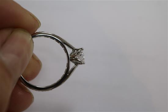 A modern platinum and single stone diamond ring with diamond set shank, size M.